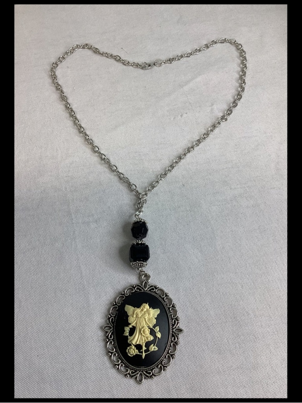 Vintage-Inspired Silver Pendant Necklace with Black and Gold Cameo.1